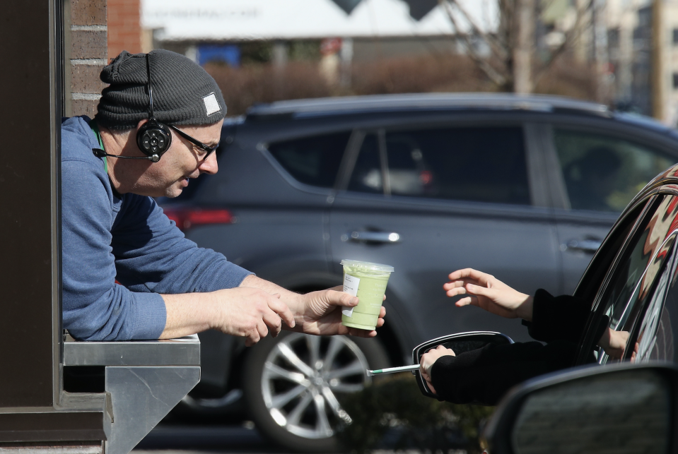 Customers of a Starbucks use the drive up window on March 18, 2020 in Hicksville, New York. (Photo: Bruce Bennett/Getty Images) 