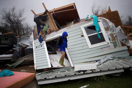 Barbara Koster stands on her front door as she surveys her property which was left devastated by Hurricane Harvey in Rockport, Texas, U.S. August 26, 2017. REUTERS/Adrees Latif