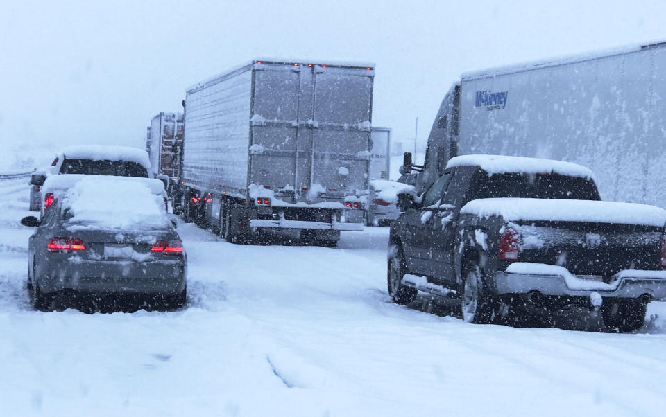 This photo provided by Johnny Lim shows a snow covered northbound I-15 in the Cajon Pass between the San Bernardino Mountains and the San Gabriel Mountains in Southern California on Thursday, Dec. 26, 2019. Lim, of Corona, said he's been stuck in his vehicle for about five hours on his way to Las Vegas. A powerful winter storm brought a deluge of rain and snow to Southern California, triggering tornado warnings and bringing post-Christmas travel to a halt on major routes. (Johnny Lim via AP)