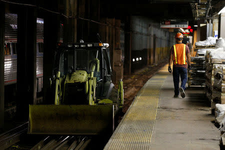 Amtrak track workers work inside the tunnel at New York's Pennsylvania Station which began track repairs causing massive disruptions to commuters in New York City, U.S., July 10, 2017. REUTERS/Brendan McDermid