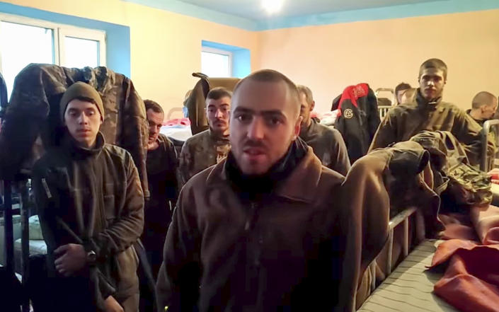 A still image from a video released by the Russian Defense Ministry shows Ukrainian servicemen in a penal colony.