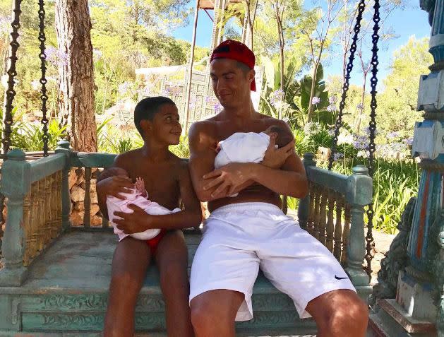 Cristiano Ronaldo looked every bit the proud father as he and his 7-year-old son Cristiano Jr. cuddled the soccer star's newborn twins Mateo and Eva on July 4, 2017. "Blessed," he wrote alongside the shot of himself and his growing family. The Real Madrid player announced the birth of his twins last week in a Facebook photo of himself holding the twins.