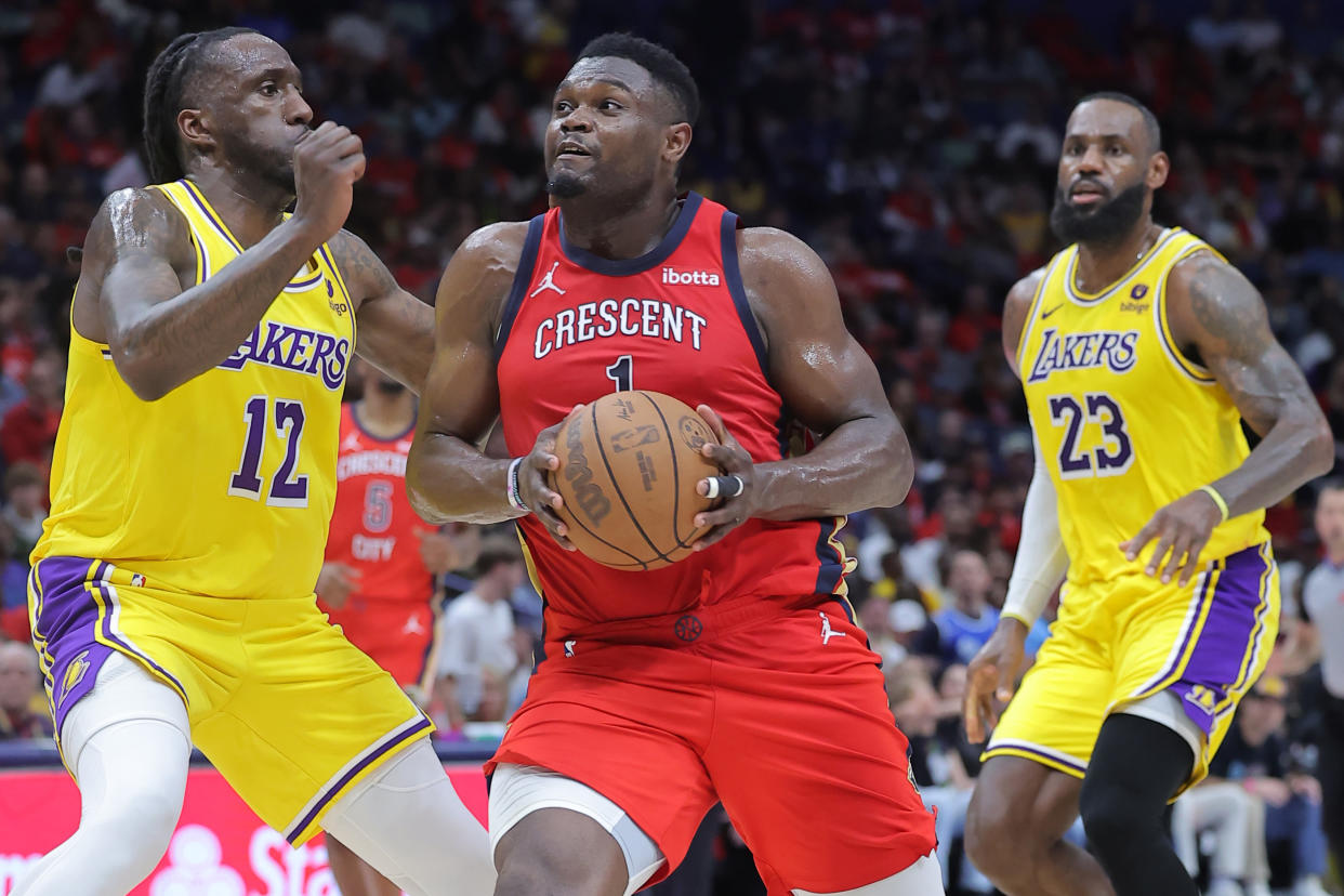 NEW ORLEANS, LOUISIANA - APRIL 16: Zion Williamson #1 of the New Orleans Pelicans drives against Taurean Prince #12 and LeBron James #23 of the Los Angeles Lakers during the first half of a game at the Smoothie King Center on April 16, 2024 in New Orleans, Louisiana. NOTE TO USER: User expressly acknowledges and agrees that, by downloading and or using this Photograph, user is consenting to the terms and conditions of the Getty Images License Agreement. (Photo by Jonathan Bachman/Getty Images)