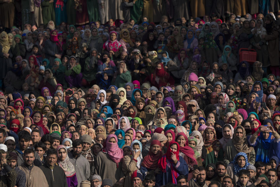 Kashmiri villagers watch the funeral procession of a local rebel Muzamil Ahmed Dar in Rahmoo village south of Srinagar, Indian controlled Kashmir, Saturday, Dec. 29, 2018. Anti-India protests and clashes erupted in disputed Kashmir on Saturday after a gunbattle between militants and government forces killed four rebels, police and residents said. (AP Photo/ Dar Yasin)