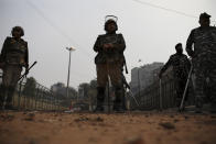 Indian paramilitary soldiers stand guard at an area that saw violence on Tuesday in New Delhi, India, Wednesday, Feb. 26, 2020. At least 20 people were killed in three days of clashes in New Delhi, with the death toll expected to rise as hospitals were overflowed with dozens of injured people, authorities said Wednesday. The clashes between Hindu mobs and Muslims protesting a contentious new citizenship law that fast-tracks naturalization for foreign-born religious minorities of all major faiths in South Asia except Islam escalated Tuesday. (AP Photo/Altaf Qadri)