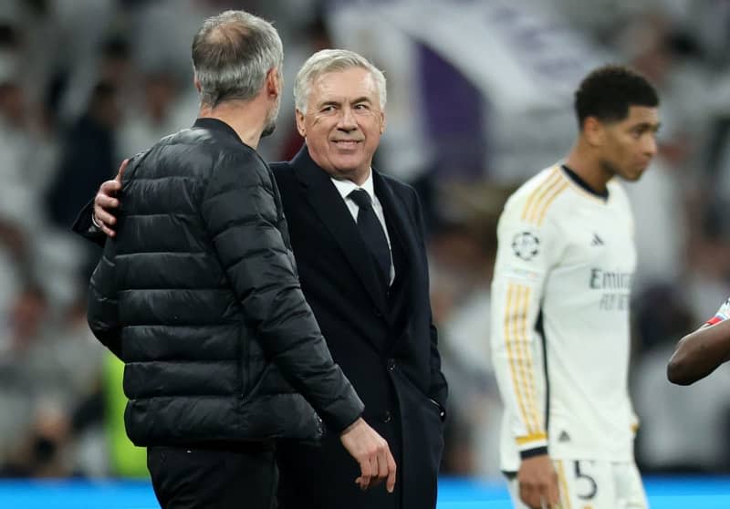 Real Madrid coach Carlo Ancelotti (C) talks with Leipzig coach Marco Rose after the UEFA Champions League round of 16 second leg soccer match between Real Madrid and RB Leipzig at Santiago Bernabeu Stadium. Jan Woitas/dpa