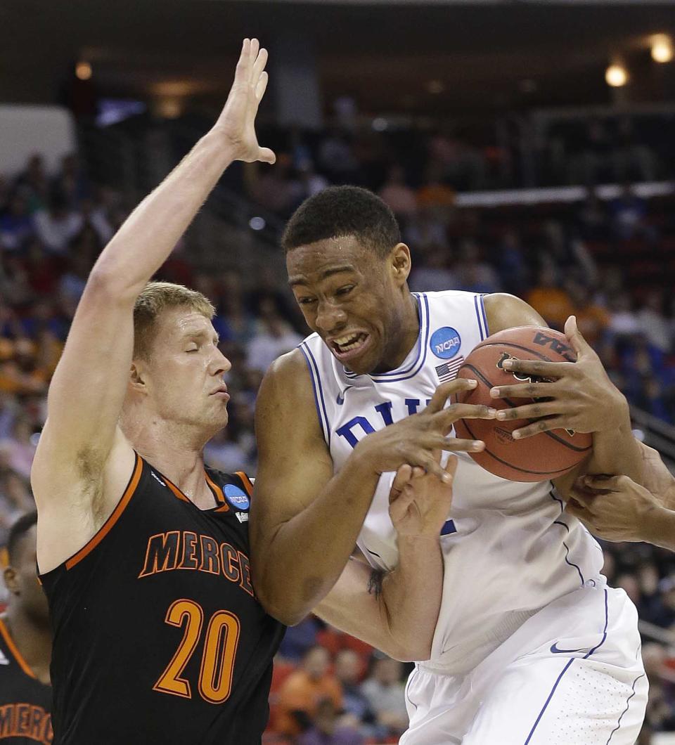 Duke forward Jabari Parker (1) works against Mercer forward Jakob Gollon (20) during the first half of an NCAA college basketball second-round game, Friday, March 21, 2014, in Raleigh, N.C. (AP Photo/Gerry Broome)