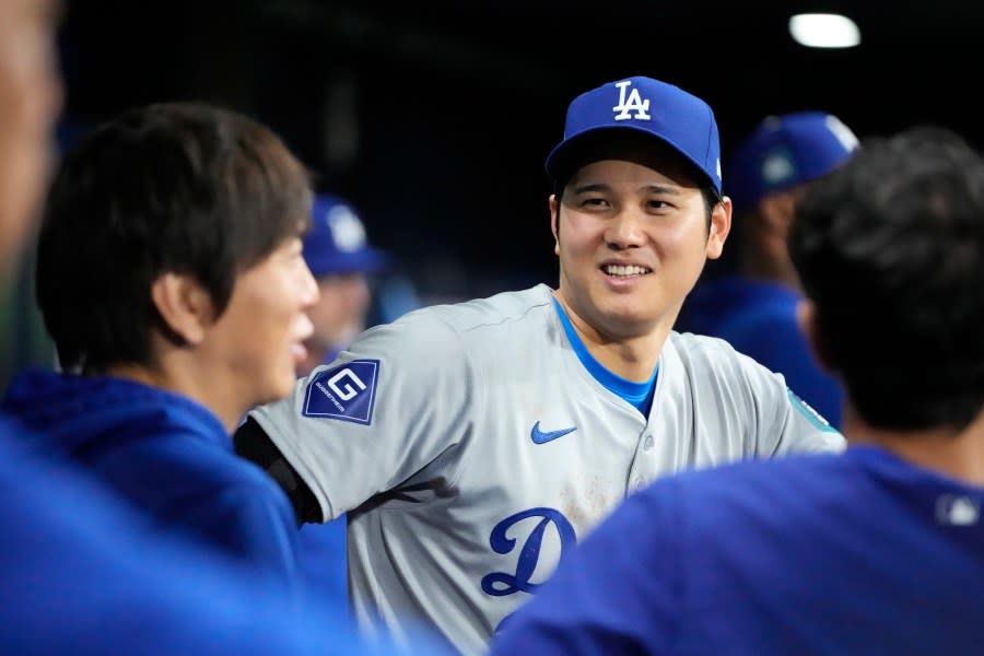 Los Angeles Dodgers designated hitter Shohei Ohtani, right, talks with interpreter Ippei Mizuhara during the ninth inning of an opening day baseball game against the San Diego Padres at the Gocheok Sky Dome in Seoul, South Korea Wednesday, March 20, 2024, in Seoul, South Korea. (AP Photo/Lee Jin-man)