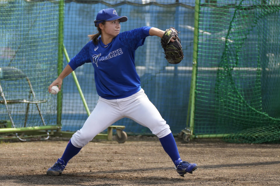 Eri Yoshida of a Japanese women's team Agekke, plays catch during her team practice in Oyama, Tochigi prefecture, north of Tokyo, Tuesday, May 30, 2023. The 31-year-old Japanese woman is a knuckleball pitcher with a sidearm delivery that she hopes might carry her to the big leagues in the United States or Japan. (AP Photo/Shuji Kajiyama)