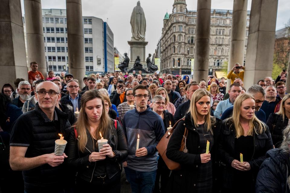 People hold candles during a vigil at Belfast City Hall in memory of murdered journalist Lyra McKee (PA)