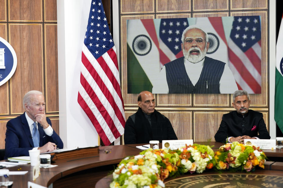 President Joe Biden meets virtually with Indian Prime Minister Narendra Modi in the South Court Auditorium on the White House campus in Washington, Monday, April 11, 2022. Indian Minister of Defense Rajnath Singh is center, Minister of External Affairs Subrahmanyam Jaishankar is right. (AP Photo/Carolyn Kaster)