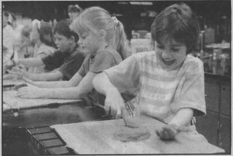 Elementary school students form concrete "donuts" in the 1993 LEAPS program at UW Fond du Lac.