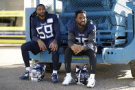 Tennessee Titans' linebacker Wesley Woodyard, left, and cornerback Logan Ryan react as they are photographed waiting their turn to give press conferences after an NFL training session at Syon House, in Syon Park, south west London, Friday, Oct. 19, 2018. The Tennessee Titans are preparing for an NFL regular season game against the Los Angeles Chargers in London on Sunday. (AP Photo/Matt Dunham)