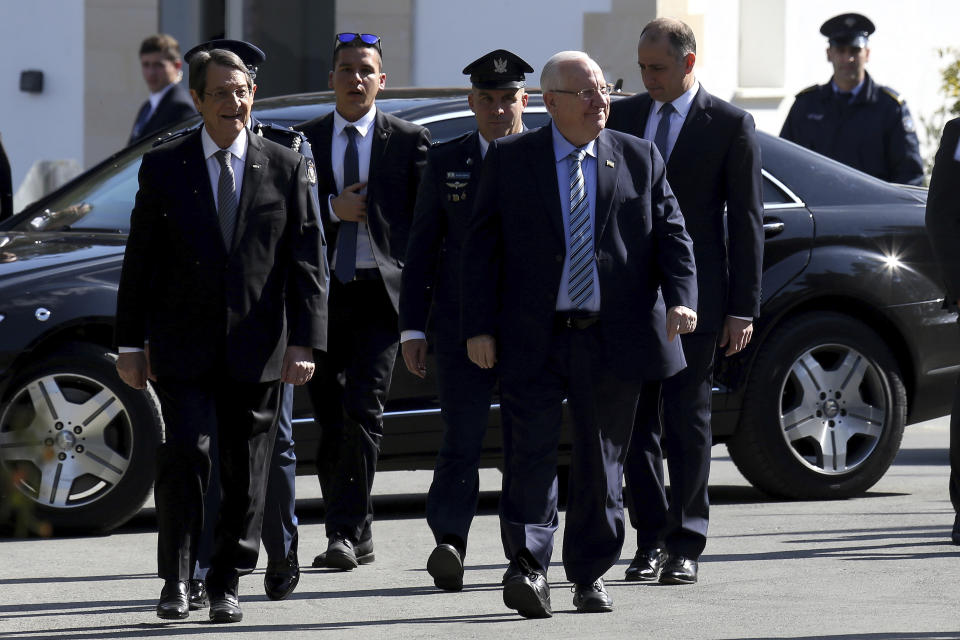 Cyprus' president Nicos Anastasiades, left, and Israel's President Reuven Rivlin walk during a welcome ceremony at the presidential palace in divided capital Nicosia, Cyprus, on Tuesday, Feb. 12, 2019. Rivlin is in Cyprus for a one-day official visit for talks. (AP Photo/Petros Karadjias)