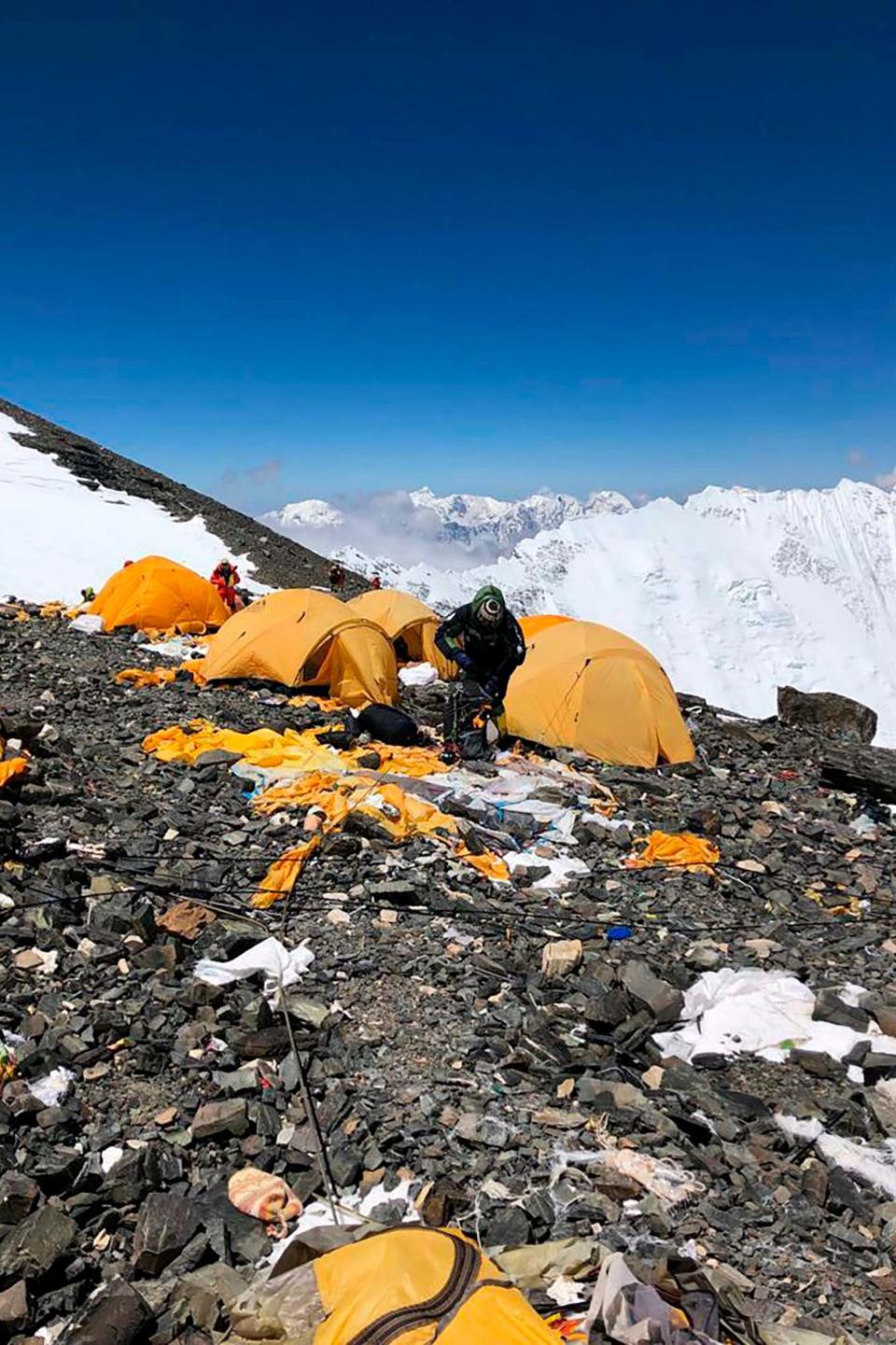 The record number of climbers on Mount Everest this season has left a cleanup crew grappling with how to clear away everything (AP)