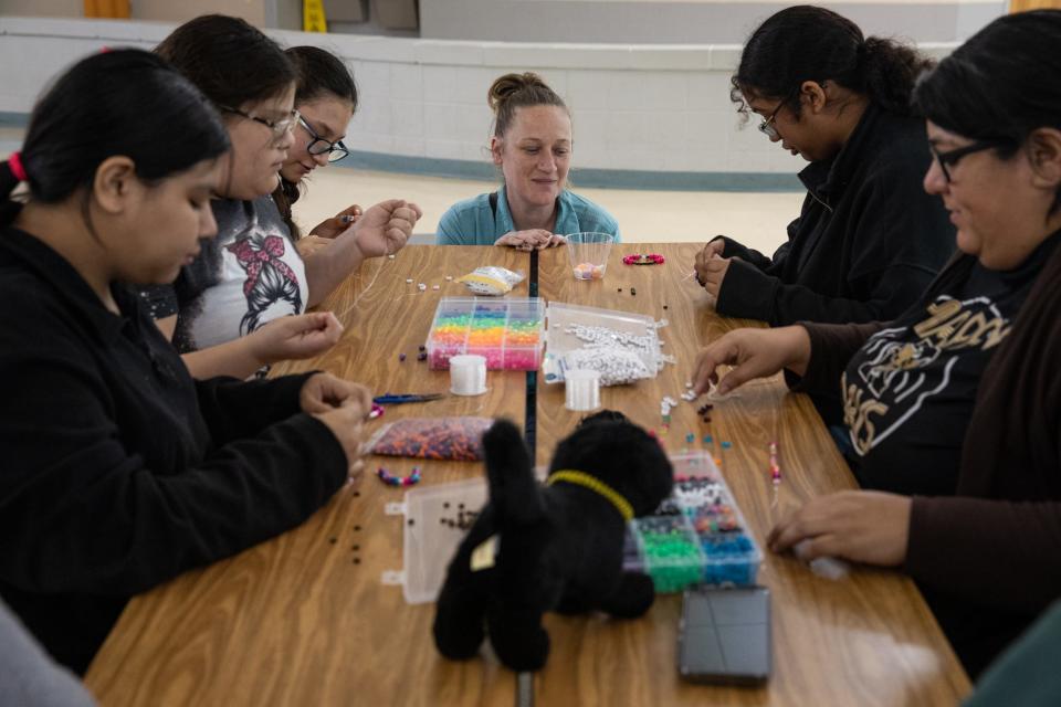 Assistant Principal Haley Vera speaks to students making bracelets during Girls Club at John S. Gillett Middle School on Friday, Feb. 9, 2024, in Kingsville, Texas.