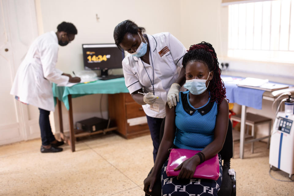 MASAKA, UGANDA - MARCH 17: A nurse injects a participant with a trial dose of PrepVacc on March 17, 2022 in Masaka, Uganda. The African-led project, which is run by The Uganda Virus Research Institute with the support of several European countries, is one of only two HIV vaccine efficacy trials currently taking place. The trials, the first of their kind in Africa, will involve 1668 people across Uganda, Tanzania and South Africa. The trial is combining experimental HIV vaccines and pre-exposure prophylaxis (PrEP) simultaneously, something that has never been done before. It is scheduled to conclude by the end of 2024. (Photo by Luke Dray/Getty Images)