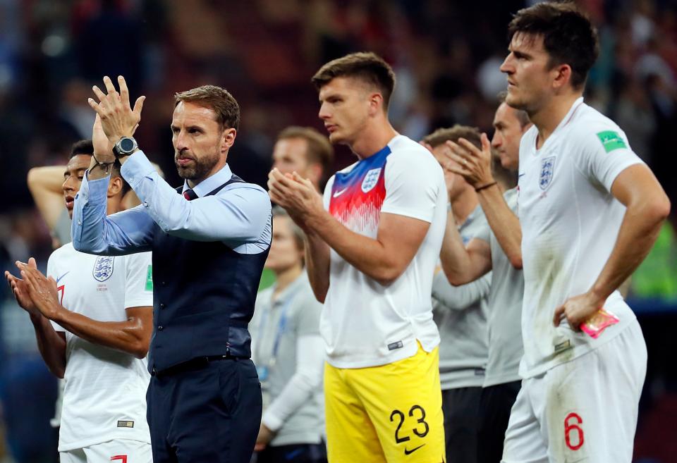 Gareth Southgate leads the team in a round of applause to fans after they were knocked out of the World Cup: EPA