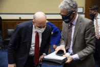 United States Postal Service Postmaster General Louis DeJoy, left, speaks with President of the American Postal Workers Union, AFL-CIO, Mark Dimondstein, after a House Oversight and Reform Committee hearing on "Legislative Proposals to Put the Postal Service on Sustainable Financial Footing" on Capitol Hill, Wednesday, Feb. 24, 2021, in Washington. (Graeme Jennings/Pool via AP)