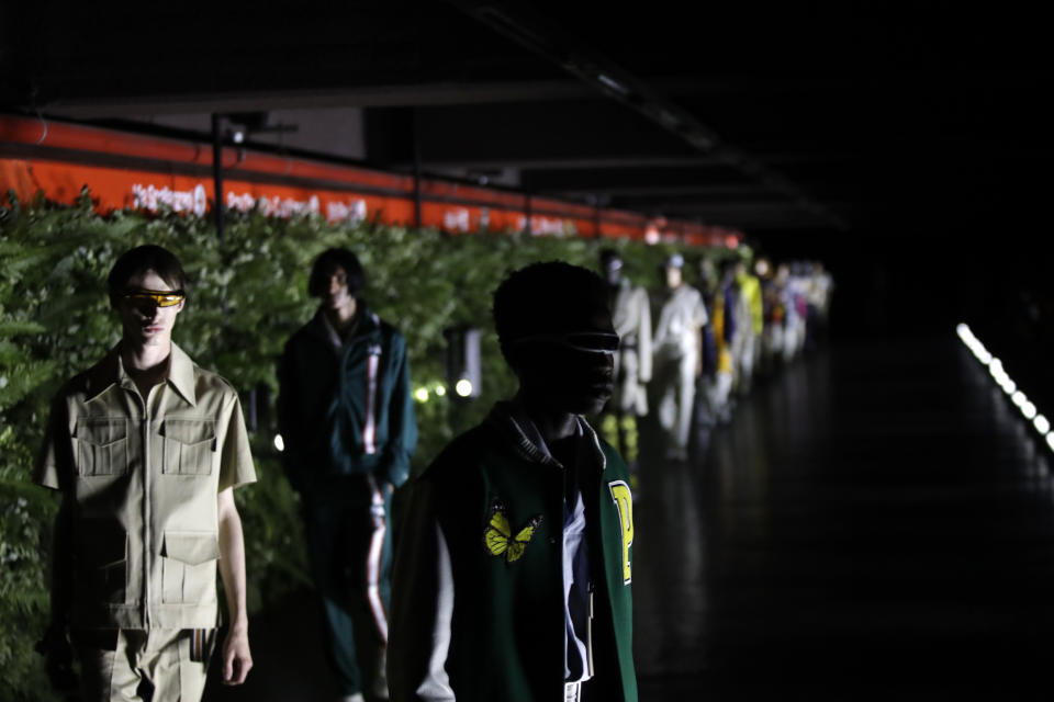 Models wear creations as part of the Palm Angels men's Spring-Summer 2020 collection, unveiled during the fashion week, in Milan, Italy, Sunday, June 16, 2019. (AP Photo/Luca Bruno)