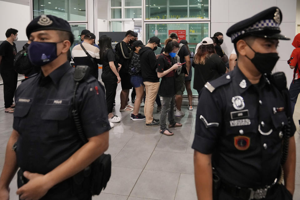 Malaysian youths rescued from human traffickers in Cambodia arrive at the Kuala Lumpur Airport Terminal in Sepang, Malaysia, Friday, Sept. 9, 2022. Foreign Minister Saifuddin Abdullah urged Malaysians to be wary of offers of lucrative jobs and free holidays, as he brought back the two dozen youths. (AP Photo/Vincent Thian)