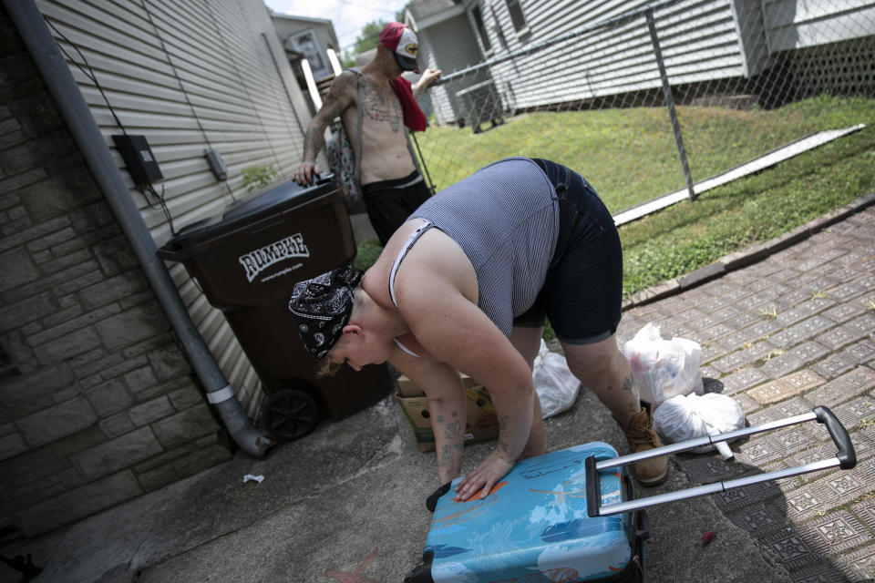 Brittany Cunningham 31, fills her suitcase with food donations accompanied by her fiance in Nelsonville, Ohio, on Friday, July 24, 2020. Brittany, a heroin addict, has been homeless for ten years. (AP Photo/Wong Maye-E)