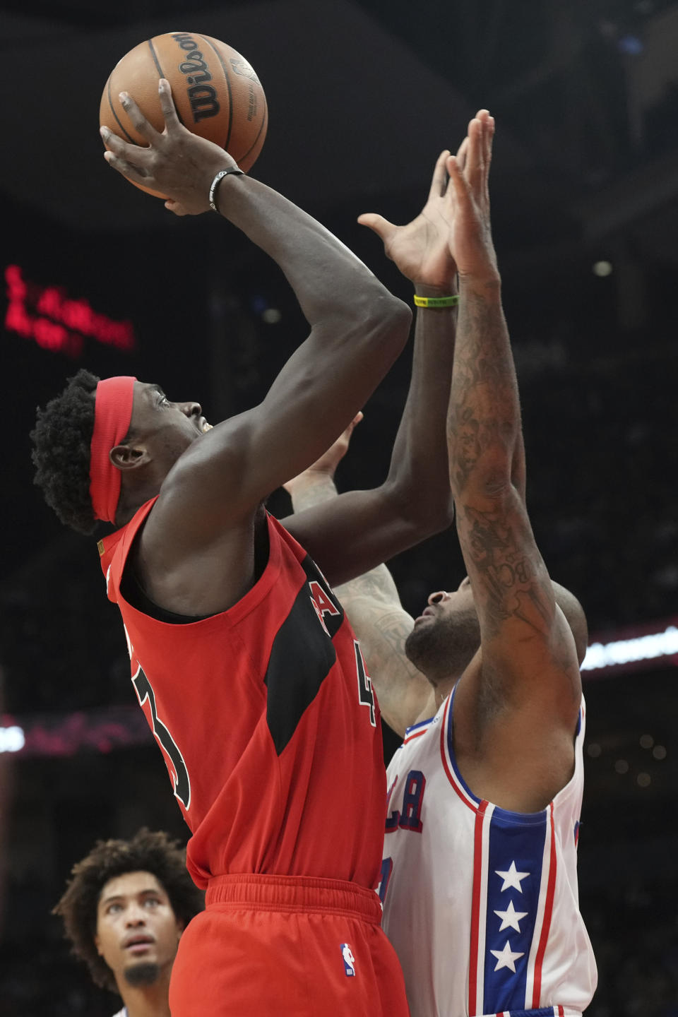 Toronto Raptors' Pascal Siakam shoots against Philadelphia 76ers' P.J. Tucker during the first half of an NBA basketball game Saturday, Oct. 28, 2023, in Toronto. (Chris Young/The Canadian Press via AP)