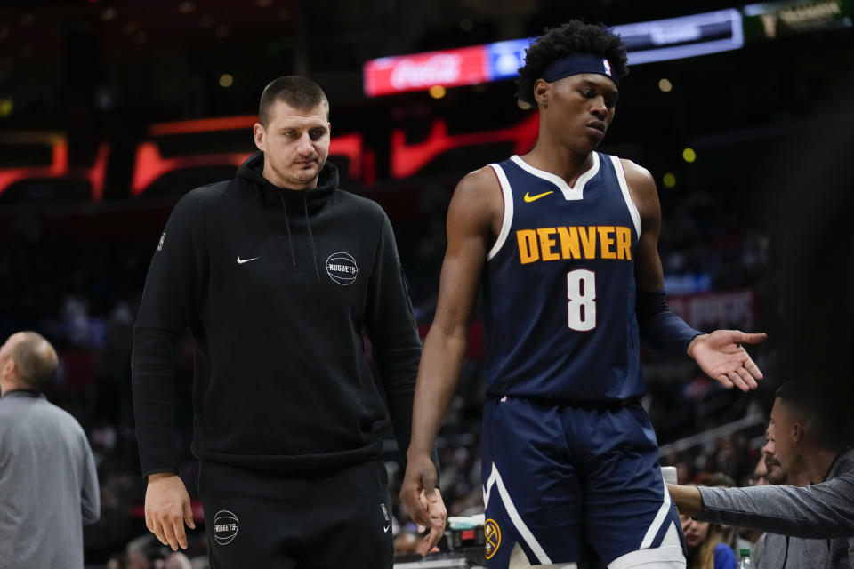 Denver Nuggets' Nikola Jokic, left, walks with forward Peyton Watson (8) on the sideline during the second half of a preseason NBA basketball game against the Los Angeles Clippers in Los Angeles, Tuesday, Oct. 17, 2023. (AP Photo/Ashley Landis)