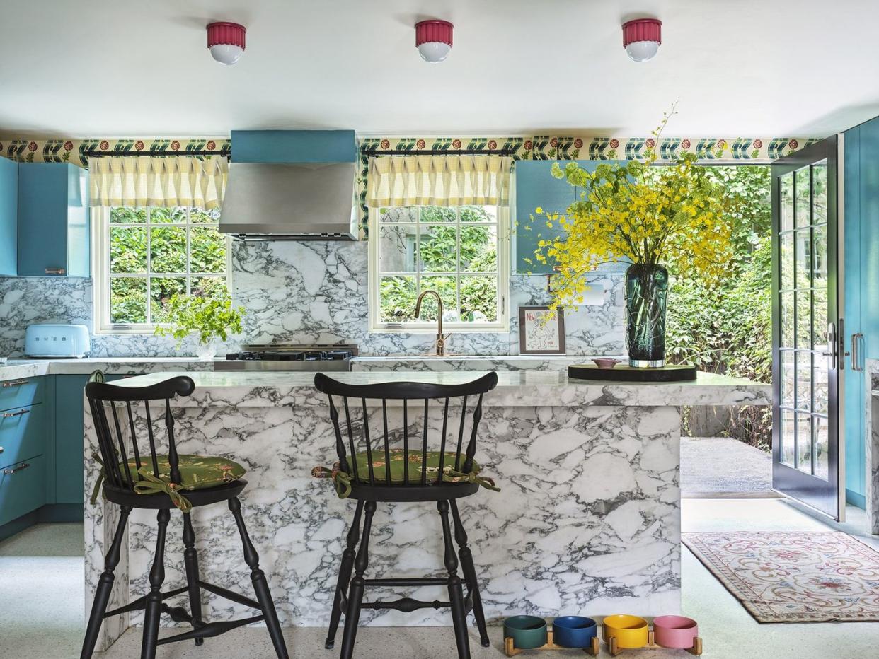 a kitchen with a table and chairs