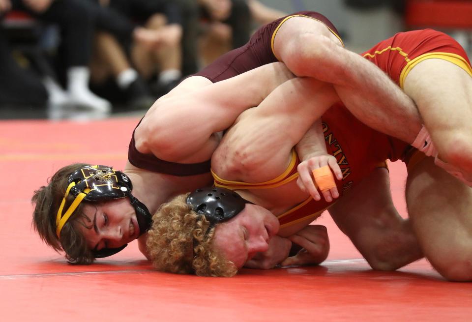 Westerville North's Evan Butcher and Big Walnut's Vincent Giordano compete in their 132-pound match during a dual meet Jan. 27, at Big Walnut High School.