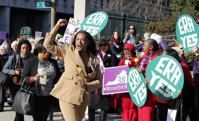 Delegate Jennifer Carroll Foy, D-Price William, cheers on Equal Rights Amendment demonstrators outside the Capitol in Richmond, Va., Wednesday, Jan. 9, 2019. The 2019 session of the General Assembly opens today. (AP Photo/Steve Helber)