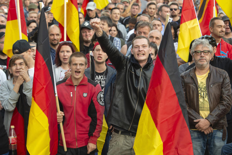 FILE - In this Friday, Sept.7, 2018 file photo, people attend a demonstration in Chemnitz, eastern Germany, after several nationalist groups called for marches protesting the killing of a German man two weeks earlier, allegedly by migrants from Syria and Iraq. Despite the rhetoric about migration crises in Europe and the U.S., the top three countries taking in refugees are Turkey, Pakistan and Uganda. Germany comes in a distant fifth. (AP Photo/Jens Meyer)