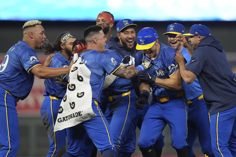 Minnesota Twins' Max Kepler, third from right, celebrates with teammates after driving in the winning run against the Oakland Athletics during the 10th inning of a baseball game Friday, June 14, 2024, in Minneapolis. (AP Photo/Abbie Parr)