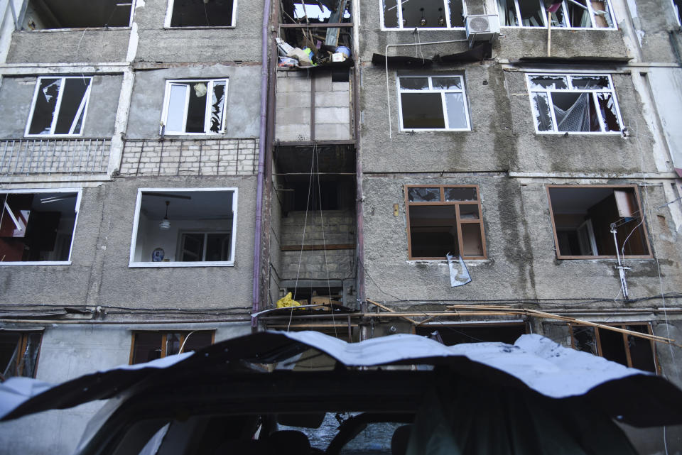 A residential area and cars that were allegedly damaged by shelling are seen during a military conflict in self-proclaimed Republic of Nagorno-Karabakh, Stepanakert, Azerbaijan, Saturday, Oct. 3, 2020. The fighting is the biggest escalation in years in the decades-long dispute over the region, which lies within Azerbaijan but is controlled by local ethnic Armenian forces backed by Armenia. (David Ghahramanyan/NKR InfoCenter PAN Photo via AP)