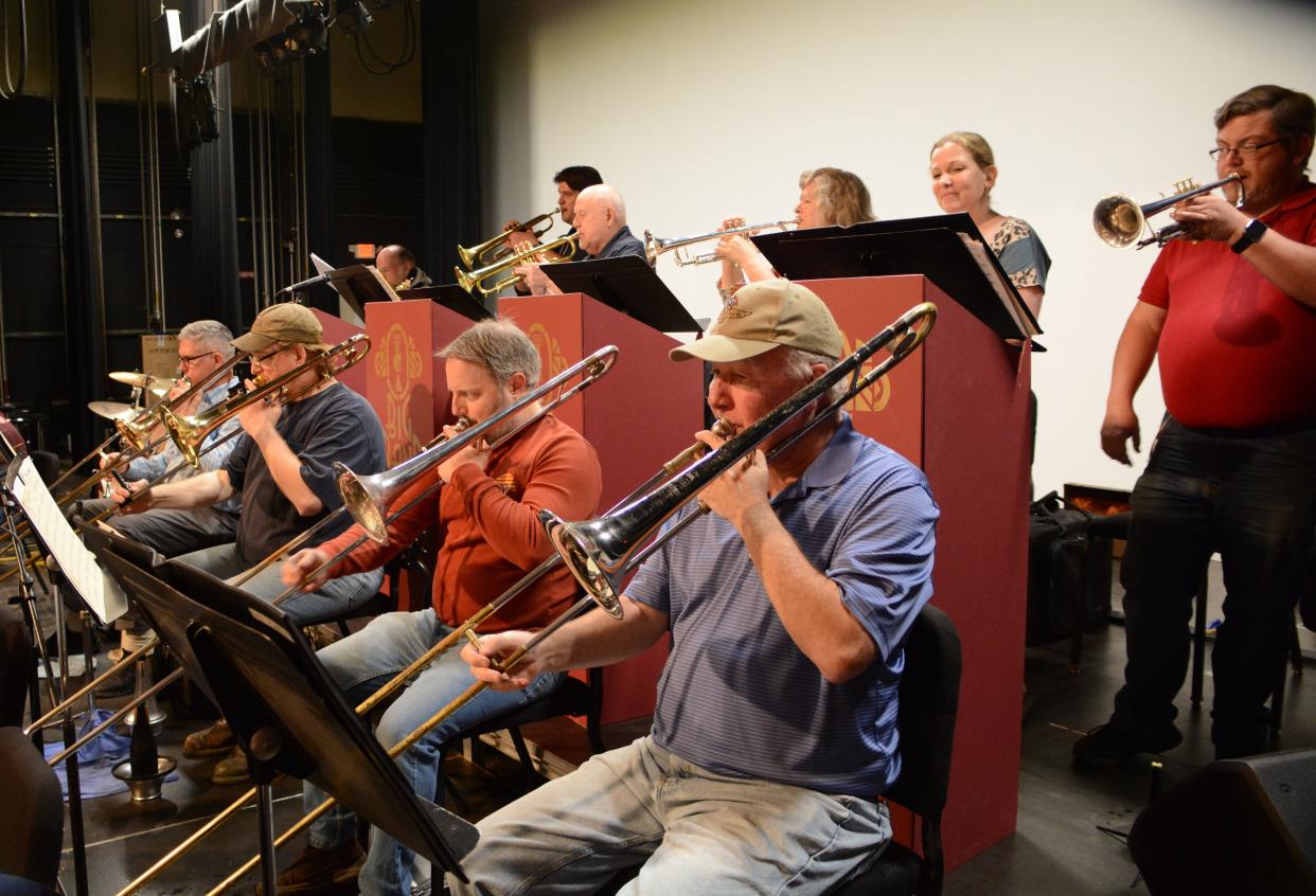 TCA Big Band trombones, from left, Robert Tallman, Bill Murray, Andy Custer and Don Segrist, and trumpets, from left, Jay Demski, Larry Harper, Susan Bickerstaff, Heather VanDaele and Neil Coats, rehearse "Easy to Love" by Cole Porter. The TCA Big Band and VocalAires will feature Porter's music in their concert May 15 at the Tecumseh Center for the Arts.