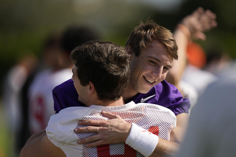 Clemson Tigers quarterback Cade Klubnik (2) hugs a teammate at the start of a practice session ahead of the 2022 Orange Bowl, Wednesday, Dec. 28, 2022, in Fort Lauderdale, Fla. Clemson will face the Tennessee Volunteers in the Orange Bowl on Friday, Dec. 30. (AP Photo/Rebecca Blackwell)