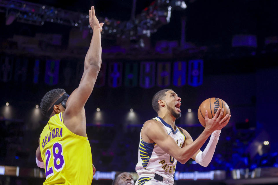 Indiana Pacers guard Tyrese Haliburton (0) goes up for a basket past Los Angeles Lakers forward Rui Hachimura (28) during the first half of the championship game in the NBA basketball In-Season Tournament on Saturday, Dec. 9, 2023, in Las Vegas. (AP Photo/Ian Maule)