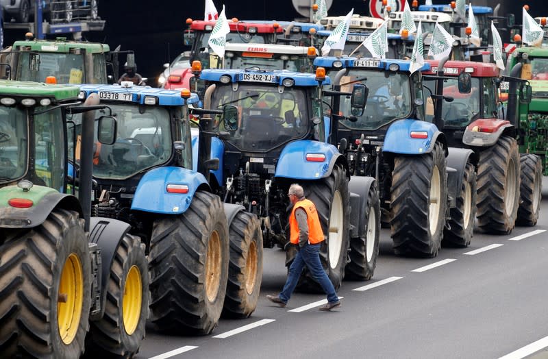 French farmers block the ring road with their tractors during a day of protest in Paris