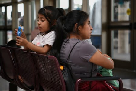 FILE PHOTO: Central American migrant families recently released from federal detention wait to board buses at a bus depot in McAllen