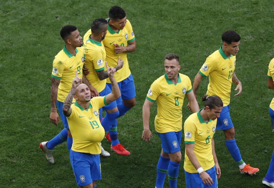 Brazil's Everton, left below, celebrates scoring his side's third goal during a Copa America Group A soccer match against Peru at the Arena Corinthians in Sao Paulo, Brazil, Saturday, June 22, 2019. (AP Photo/Nelson Antoine)