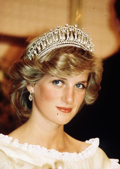 <div class="inline-image__caption"><p>Diana, Princess of Wales, wearing a cream satin dress by Gina Fratini with the Queen Mary Cambridge Lover’s Knot Tiara and diamond earrings attends a banquet on April 29, 1983 in Auckland, New Zealand.</p></div> <div class="inline-image__credit">Anwar Hussein/WireImage</div>