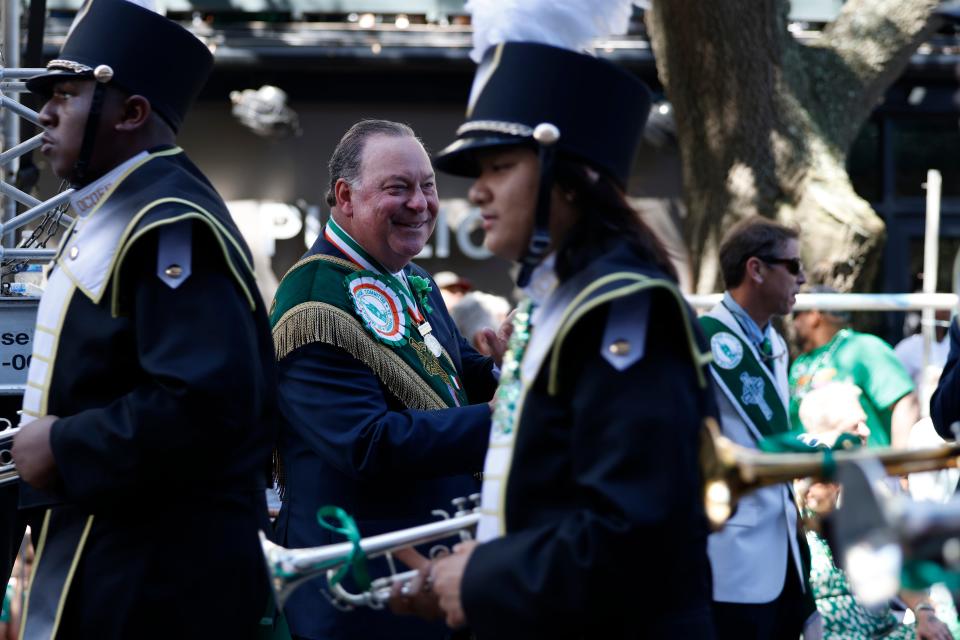 Grand Marshal John Forbes claps as the Ocoee High School (Fl) marching band passes during the Savannah St. Patrick's Day Parade on Saturday, March 16, 2024.