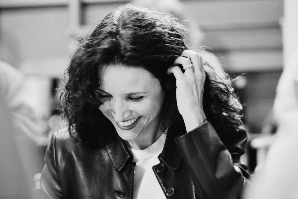 STUDIO CITY, CA - APRIL 3: (NO U.S TABLOID SALES) Actress Julia Louis Dreyfus smiles as she reads a script during the last days of shooting the hit tv show 'Seinfeld' April 3, 1998 in Studio City, California.  (Photo by David Hume Kennerly/Getty Images)