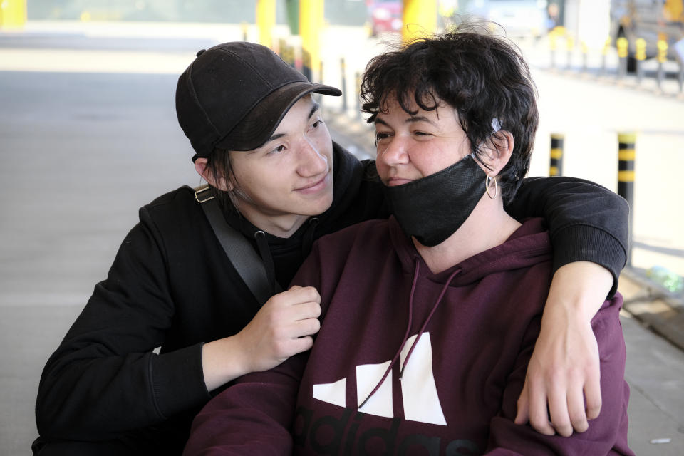 Mariana Hopulete, 43 years-old, and her son Valentin, 17 years-old, Romanian seasonal workers, pose for a portrait outside the Avram Iancu international airport, in Cluj, central Romania, Thursday, April 9, 2020. More than 1800 workers from across Romania are traveling on 12 flights to Berlin, Baden Bade and Dusseldorf in Germany, most of them to work in asparagus farms.(AP Photo/Raul Stef)