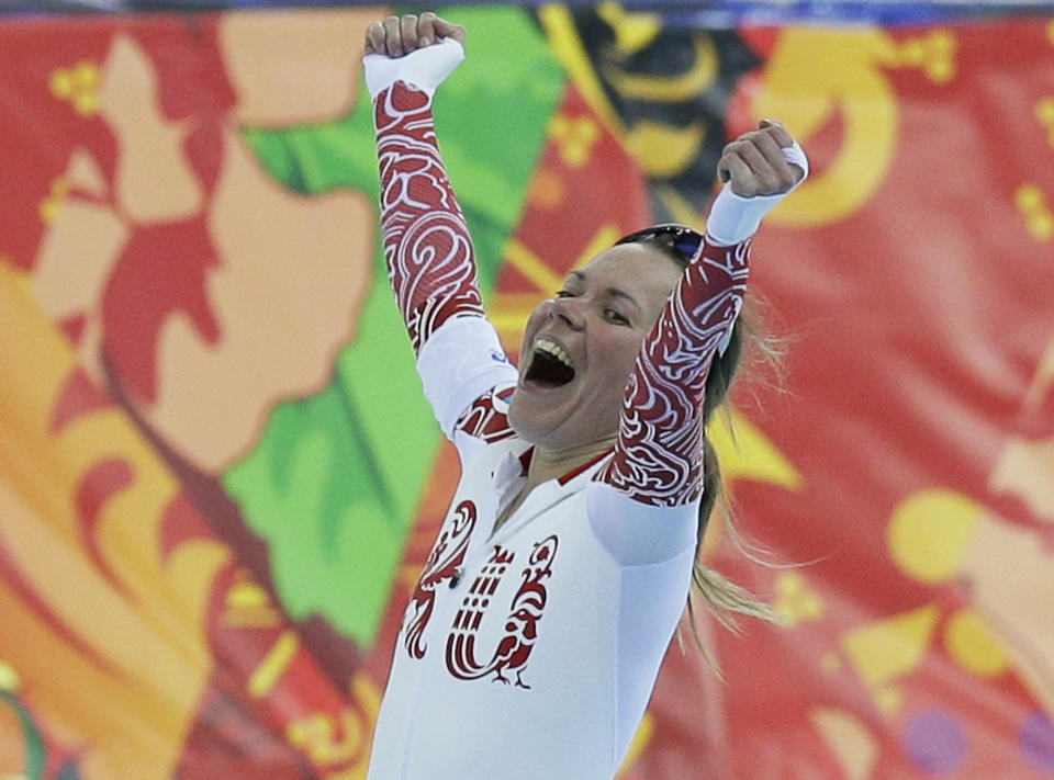 Russia's Olga Graf celebrates after winning bronze in the women's 3,000-meter speedskating race at the Adler Arena Skating Center during the 2014 Winter Olympics, Sunday, Feb. 9, 2014, in Sochi, Russia. (AP Photo/Pavel Golovkin)