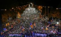 FILE PHOTO: Protesters hold the lights of their mobile phones as they wave Estelada flags during a demonstration called by pro-independence associations asking for the release of jailed Catalan activists and leaders, in Barcelona