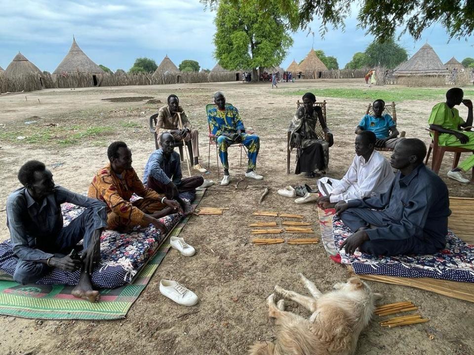 Others watch as Manyuan Kerena (right foreground) negotiates with a prospective groom (2nd from left) over the price of a dowry for his 14-year-old daughter in the village of Kueryiek, South Sudan. / Credit: CBS News