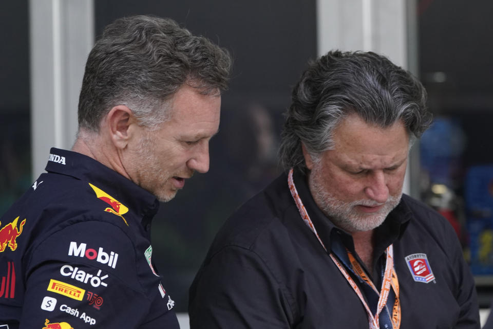 FILE - Red Bull Racing team principal Christian Horner, left, talks with Michael Andretti after the qualifying sessions for the Formula One Miami Grand Prix auto race at Miami International Autodrome, Saturday, May 7, 2022, in Miami Gardens, Fla. General Motors will attempt to enter Formula One by partnering with Andretti Global under its Cadillac banner as it supports Michael Andretti's bid to launch a two-car American team. Andretti has been lobbying the FIA, the governing body for F1, to expand the 20-car grid and join the series after a failed 2021 attempt to purchase Sauber. (AP Photo/Wilfredo Lee, File)