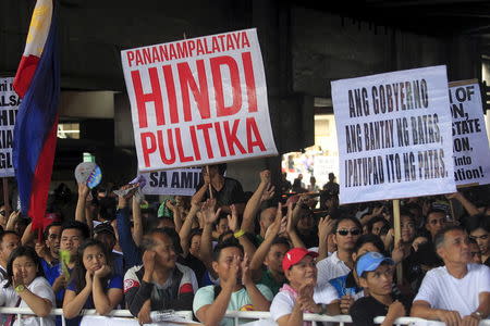 Filipino members of Iglesia ni Cristo (Church of Christ) or INC display placards during a protest in Manila August 29, 2015. A placard read at L-R: "Faith, not Politics" and "The government upholds the law and should implement it equally". REUTERS/Romeo Ranoco