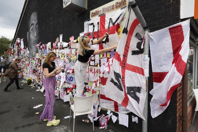 People put up flags and messages on the mural of Manchester United striker and England player Marcus Rashford (Danny Lawson/PA)